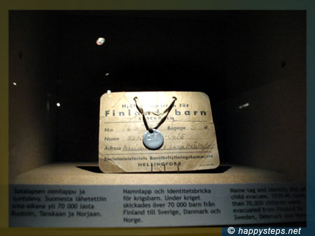 photo of a name tag and identity disc of child evacuee