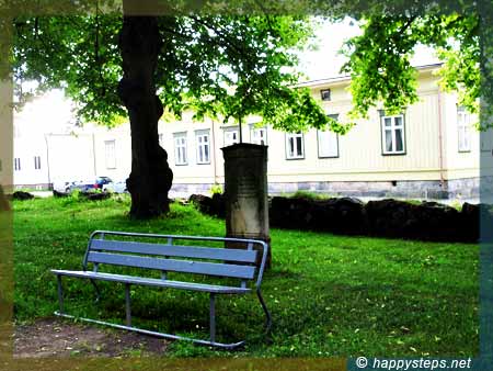 photo of a lone bench at the ruins of the Holy Trinity Church in Old Rauma